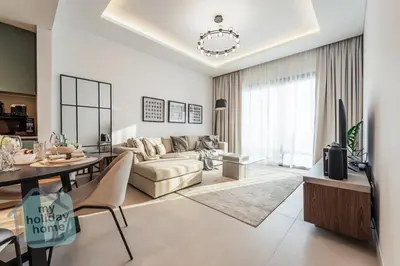 a living room with a couch and a table at Burj Khalifa View from Roof-Pool & Gym -Parking in Dubai