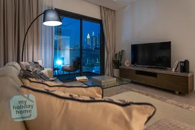 a living room with a tv and a large window at Burj Khalifa View from Roof-Pool & Gym -Parking in Dubai