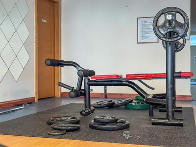 a gym with a treadmill and dumbbells on a rug at Modern Cozy Studio Near Dubai Marina in Dubai