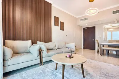 a living room with a couch and a table at 2 Bedroom Apartment Close to Miracle Tower in Dubai