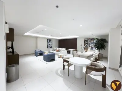 a living room with a couch and a table and chairs at Vogue Creek Harbour Edge Tower Waterfront Living Close to Downtown, Burj Khalifa and Dubai Mall, One Bedroom Apartment with Balcony and Canal View, Access to all Amenities in Dubai