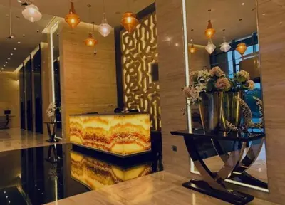 a living room with a couch and a mirror at Luxury Living In JVC in Dubai