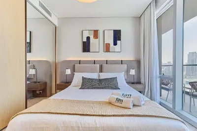 a bedroom with a large bed and a balcony at Iconic 2BR Vida Dubai Mall with Direct Mall Access in Dubai