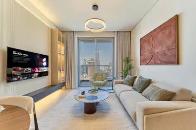 a living room with a couch and a table at Iconic 2BR Vida Dubai Mall with Direct Mall Access in Dubai