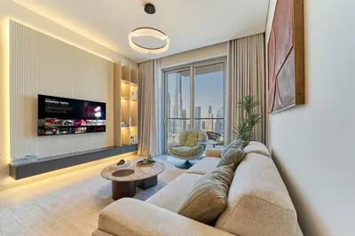 a living room with a couch and a large window at Iconic 2BR Vida Dubai Mall with Direct Mall Access in Dubai