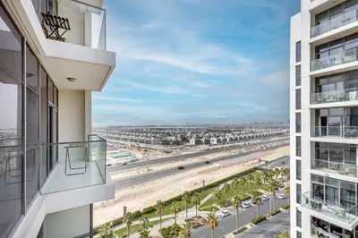 a view of the beach from the balcony of a building at Golf Promenade 2-B, Damac Hills - 2BR Apartment - Allsopp & Allsopp in Dubai