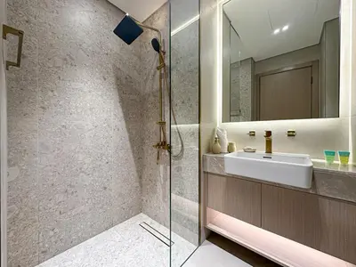 a bathroom with a sink and a shower at WelHome - Perfect Cozy Studio with Pool, Gym & Balcony in Dubai