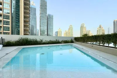 a swimming pool with a city skyline in the background at Modern 1 Bed Apartment with full Dubai Marina view in Dubai