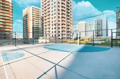 a basketball court on a balcony with tall buildings at Binghatti Phantom! Private Pool in Your Balcony! 5 Star Hotel Amenities! in Dubai