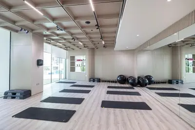 a yoga room with black mats on the floor at Binghatti Phantom! Private Pool in Your Balcony! 5 Star Hotel Amenities! in Dubai