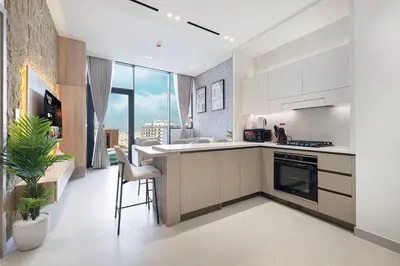a kitchen with white cabinets and a large window at Binghatti Phantom! Private Pool in Your Balcony! 5 Star Hotel Amenities! in Dubai