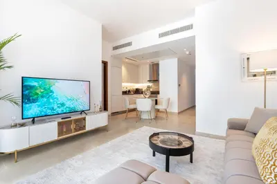 a living room with a large flat screen tv at Dubai Marina Luxury 1 BDR Holiday Apartment - Dubai Marina Walk in Dubai