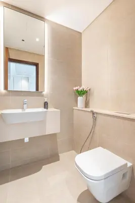 a bathroom with a sink and a toilet and a mirror at Dubai Marina Luxury 1 BDR Holiday Apartment - Dubai Marina Walk in Dubai
