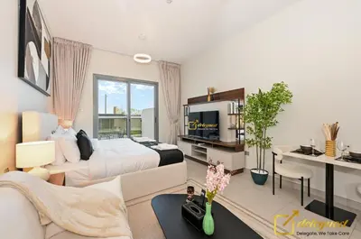 a bedroom with a bed and a tv in it at Stylish Studio with City Views in Dubai Hills in Dubai