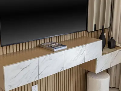 a living room with a tv on a table at Livin' Holidays - Studio - Azizi Elegant Studio in Dubai