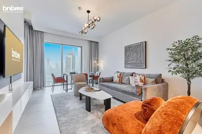 a living room with a couch and a table at bnbmehomes - Downtown Views II - Tower 1 in Dubai