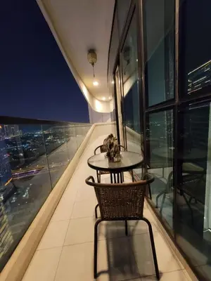 a table and chair on the top of a building at Downtown Dubai Burj Khalifa View 2 BHK Dubai Mall in Dubai