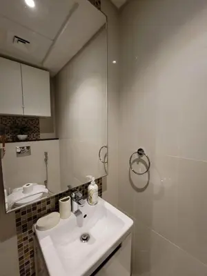 a bathroom with a sink and a mirror at Downtown Dubai Burj Khalifa View 2 BHK Dubai Mall in Dubai