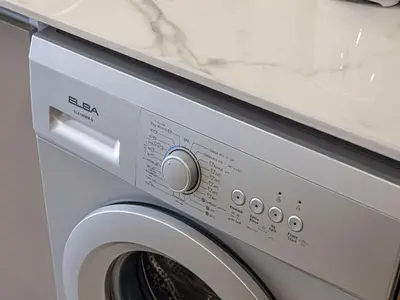 a washer and dryer with a white counter top at Livin' Holidays - Studio - Azizi Lovely Studio in Dubai