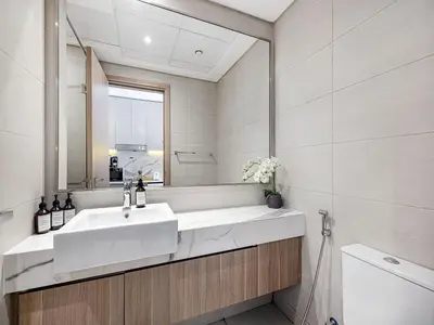 a bathroom with a sink and a mirror at Livin' Holidays - Studio - Azizi Lovely Studio in Dubai