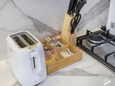 a toaster sitting on a counter next to a stove at Livin' Holidays - Studio - Azizi Lovely Studio in Dubai
