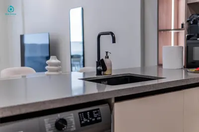 a kitchen with a sink and a counter top at Blue Breeze - Stylish 1 BR in JVC Al Serh Residence in Dubai