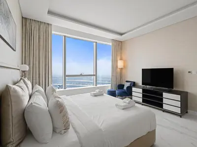 a hotel room with a large bed and a large window at Luxe Island Retreat 1BR in Palm-14 in Dubai
