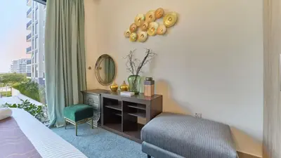 a bedroom with a desk and a chair and a mirror at 1BR Dubai Hills Executive Residence Stylish Stay in Dubai