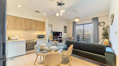 a kitchen and living room with a couch and a table at 1BR Dubai Hills Executive Residence Stylish Stay in Dubai