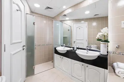 a bathroom with two sinks and a shower at Ultra-Luxury Penthouse Private Pool & Yacht Views in Dubai
