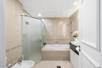 a bathroom with a shower and a tub and a sink at Ultra-Luxury Penthouse Private Pool & Yacht Views in Dubai