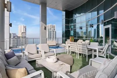 a balcony with white furniture and a view of the city at Ultra-Luxury Penthouse Private Pool & Yacht Views in Dubai