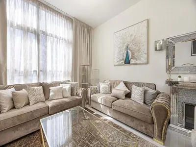 a living room with two couches and a fireplace at Livin' Holidays - 1 BR - Elegant Apartment in Dubai
