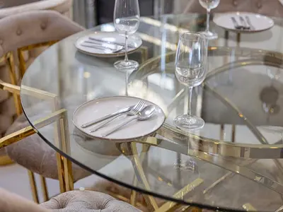 a glass table with wine glasses and silverware on it at Livin' Holidays - 1 BR - Elegant Apartment in Dubai