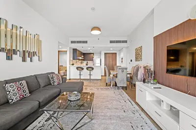 a living room with a couch and a table at Contemporary 1BR City View Apartment at 1 Residence in Dubai