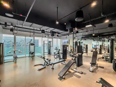 a gym with several treadmills and cardio machines at Contemporary 1BR City View Apartment at 1 Residence in Dubai