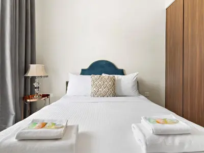 a bedroom with a white bed with two dishes on it at Executive 1BDR Sleeps 4 In Vera-Business Bay-80 in Dubai