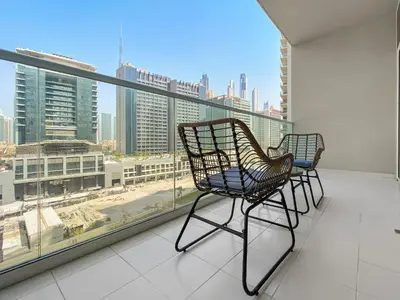two chairs on a balcony with a view of the city at Executive 1BDR Sleeps 4 In Vera-Business Bay-80 in Dubai