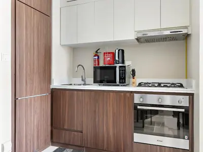 a kitchen with a stove and a microwave at Executive 1BDR Sleeps 4 In Vera-Business Bay-80 in Dubai