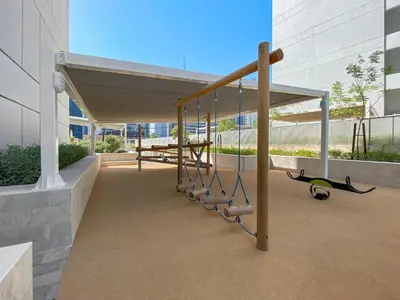 a pavilion with swings and a skateboard under it at Executive 1BDR Sleeps 4 In Vera-Business Bay-80 in Dubai