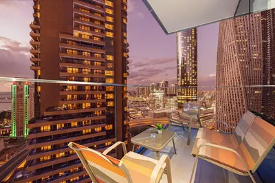 a balcony with chairs and tables and a city skyline at Marina High-Floor Premium Luxury Stay at LIV Marina for up to 9 Guests with Marina Views and Exceptional Amenities in Dubai