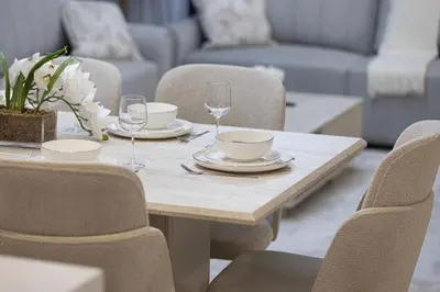 a wooden table with plates and wine glasses on it at Marina High-Floor Premium Luxury Stay at LIV Marina for up to 9 Guests with Marina Views and Exceptional Amenities in Dubai