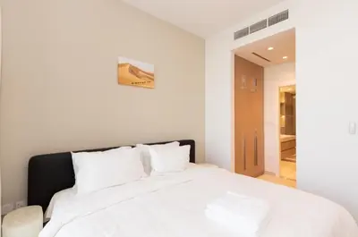 a bedroom with a white bed with white pillows at 1 BDR Ellington House, Dubai Hills in Dubai