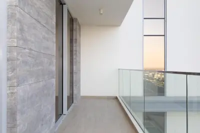 a hallway with glass walls and a balcony at 1 BDR Ellington House, Dubai Hills in Dubai