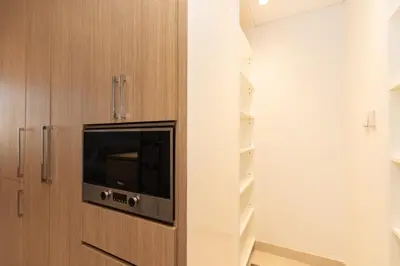 a room with a door with a tv on it at 1 BDR Ellington House, Dubai Hills in Dubai