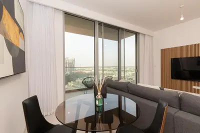 a living room with a glass table and a couch at 1 BDR Ellington House, Dubai Hills in Dubai