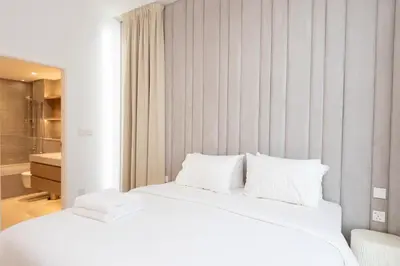 a white bed with white pillows in a bedroom at Boutique 2BDR Ellington House, Dubai Hills in Dubai