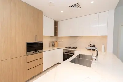 a kitchen with white cabinets and a sink at Boutique 2BDR Ellington House, Dubai Hills in Dubai