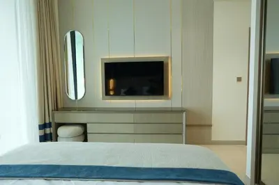 a bedroom with a bed and a tv on the wall at OLD The Royal Blue Jacuzzi Suite 3501 in Dubai