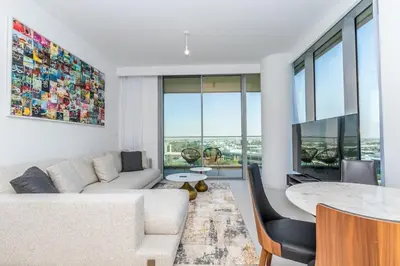 a living room with a couch and a table at Luxury 3BDR Ellington House Dubai Hills in Dubai